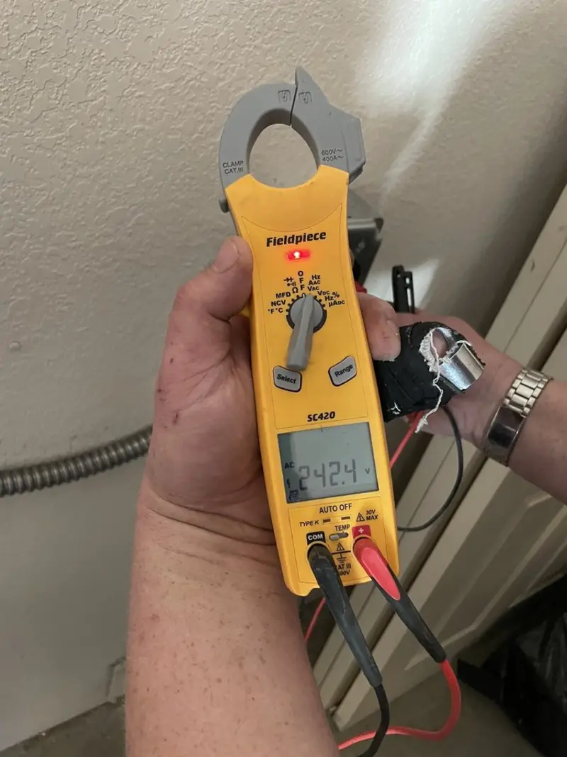 Voltage testing with clamp meter during Outlet Installation in Fillmore